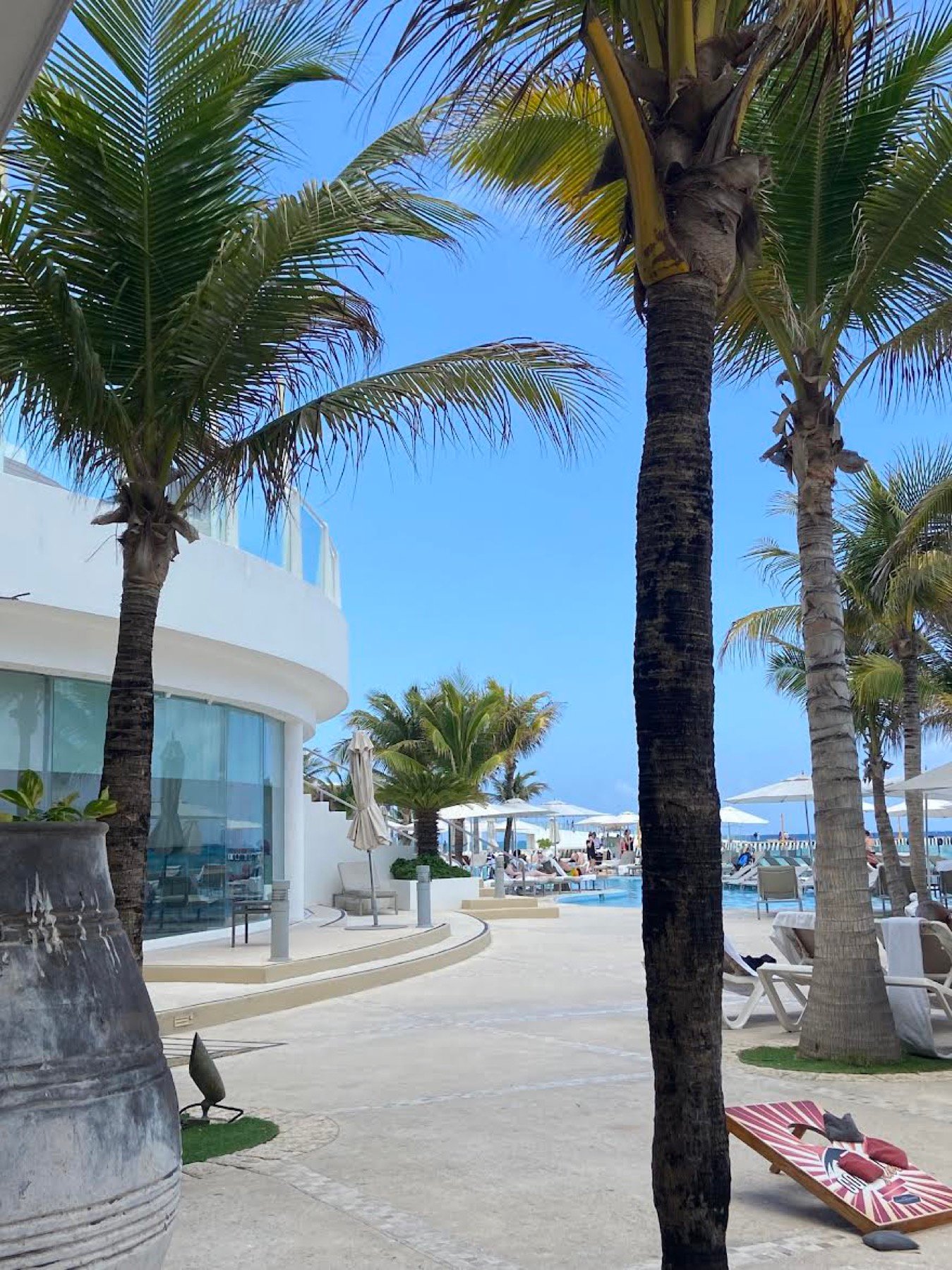 Playacar Palace palm-lined pool path